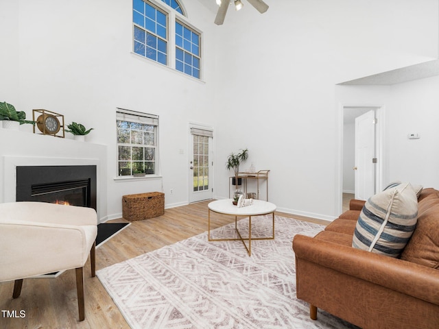 106 Mingocrest Dr, Knightdale, NC 27545 - living area featuring a ceiling fan, a glass covered fireplace, baseboards, and wood finished floors