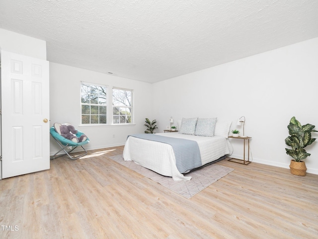 106 Mingocrest Dr, Knightdale, NC 27545 - bedroom featuring a textured ceiling, baseboards, and wood finished floors