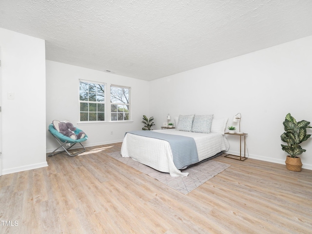 106 Mingocrest Dr, Knightdale, NC 27545 - bedroom featuring visible vents, a textured ceiling, baseboards, and wood finished floors