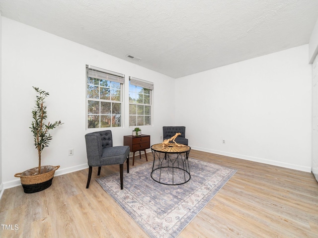 106 Mingocrest Dr, Knightdale, NC 27545 - living area featuring baseboards, visible vents, light wood-style flooring, and a textured ceiling