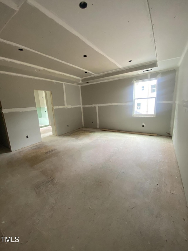 unfurnished room featuring unfinished concrete floors