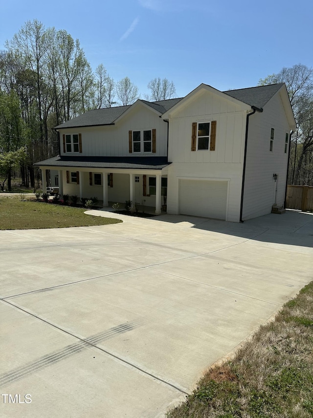 modern farmhouse style home featuring driveway, a garage, and board and batten siding