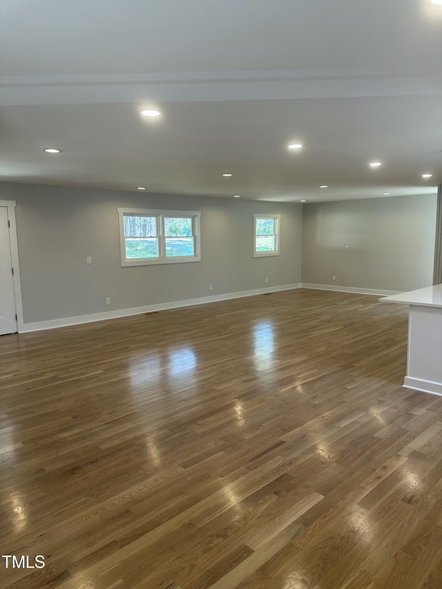 interior space featuring dark wood-style flooring, baseboards, and recessed lighting