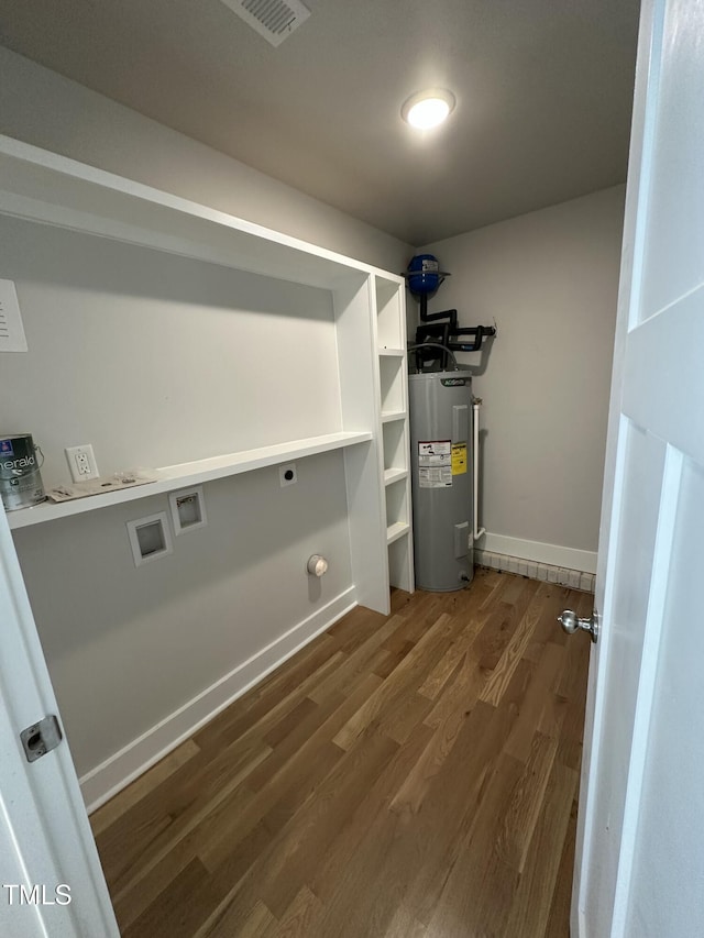 laundry room with water heater, hookup for an electric dryer, laundry area, dark wood-type flooring, and hookup for a washing machine