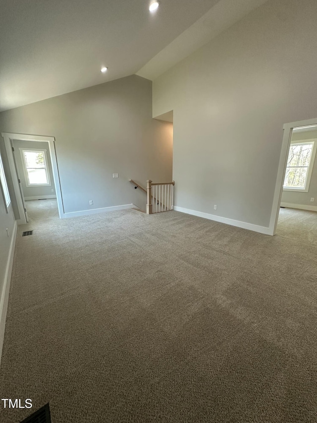spare room with baseboards, carpet, and a healthy amount of sunlight