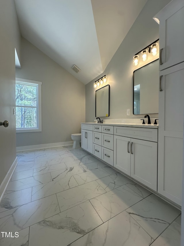 full bath featuring visible vents, baseboards, marble finish floor, double vanity, and toilet