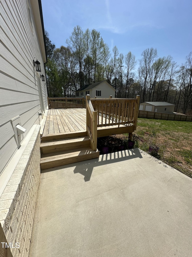 wooden deck with a patio area and fence