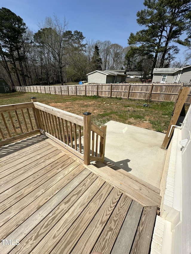 deck featuring a fenced backyard and a patio area