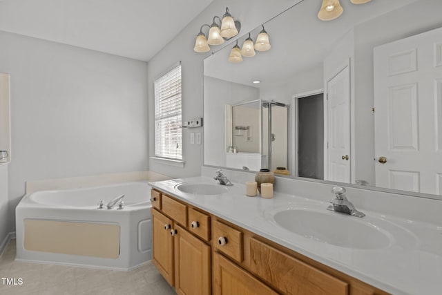 bathroom with double vanity, a sink, a stall shower, and a bath