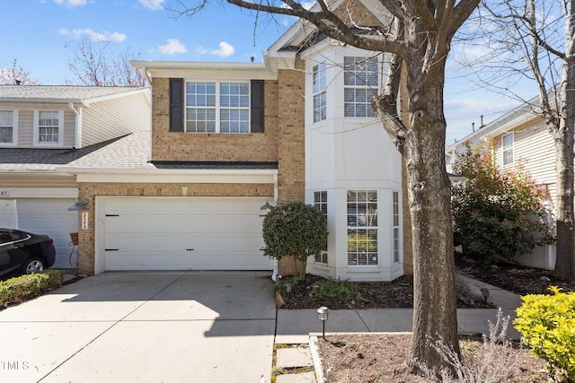 view of front of house with brick siding, concrete driveway, and an attached garage