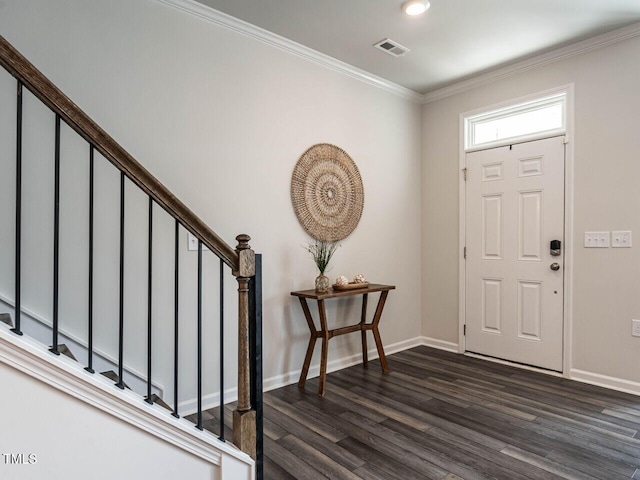 foyer entrance with visible vents, crown molding, baseboards, stairs, and dark wood finished floors