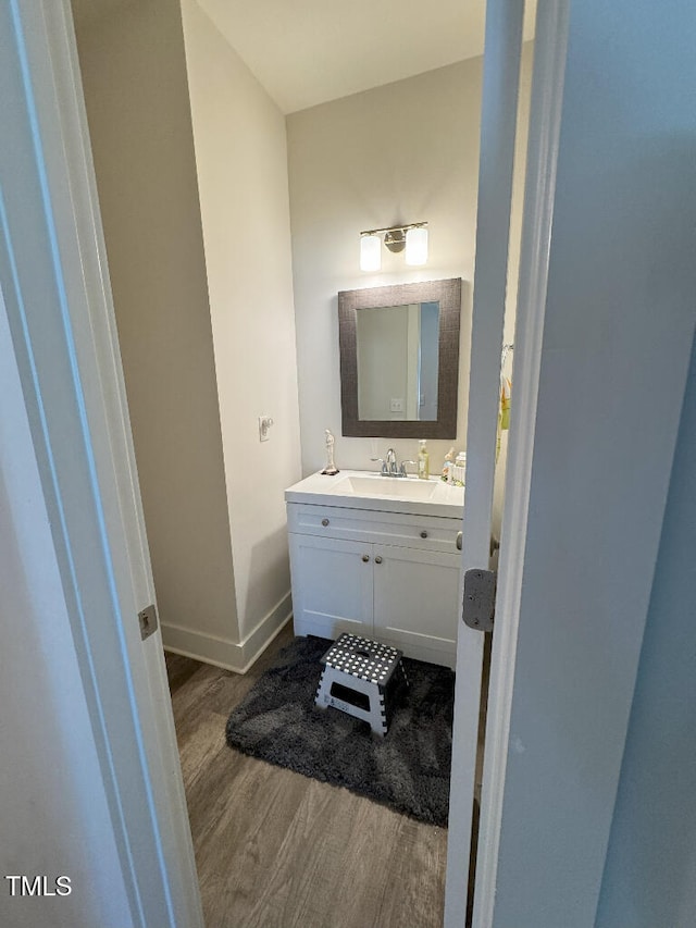 829 S Franklin St, Wake Forest, NC 27587 - bathroom with baseboards, wood finished floors, and vanity