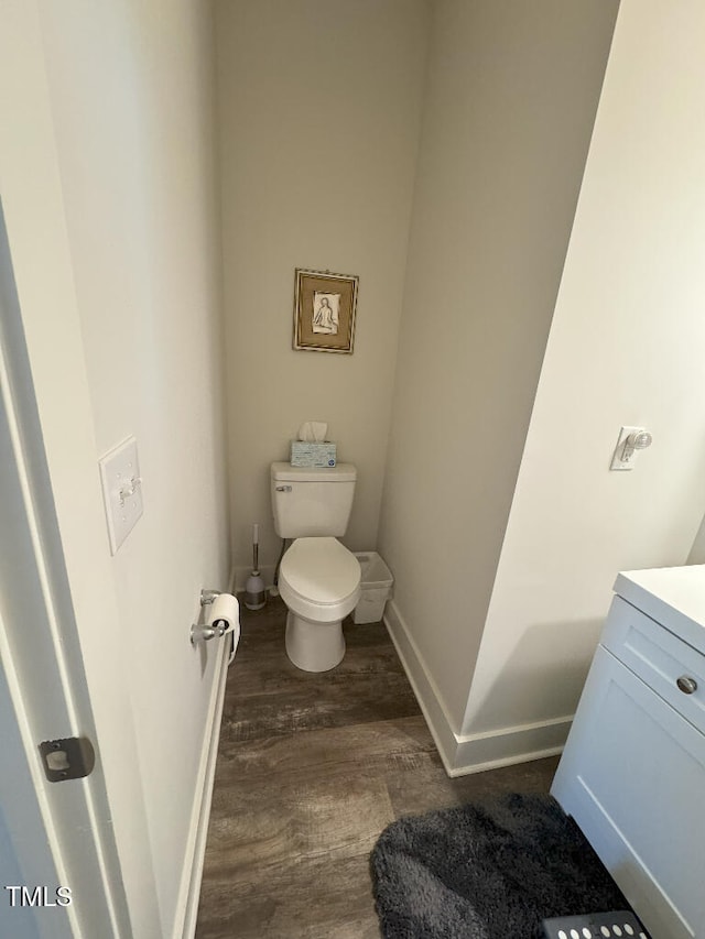 829 S Franklin St, Wake Forest, NC 27587 - bathroom featuring toilet, vanity, baseboards, and wood finished floors