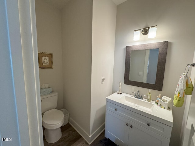 829 S Franklin St, Wake Forest, NC 27587 - bathroom with baseboards, wood finished floors, toilet, and vanity