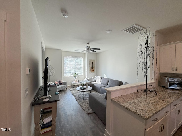 829 S Franklin St, Wake Forest, NC 27587 - living area with dark wood-type flooring, visible vents, a toaster, and a ceiling fan