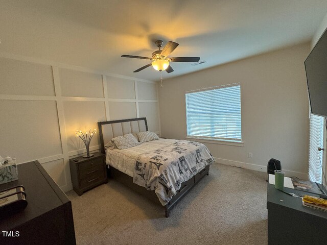 829 S Franklin St, Wake Forest, NC 27587 - bedroom with light carpet, visible vents, a decorative wall, and a ceiling fan