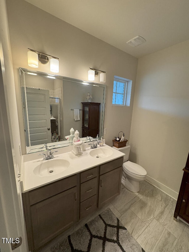 829 S Franklin St, Wake Forest, NC 27587 - full bathroom featuring double vanity, visible vents, toilet, and a sink