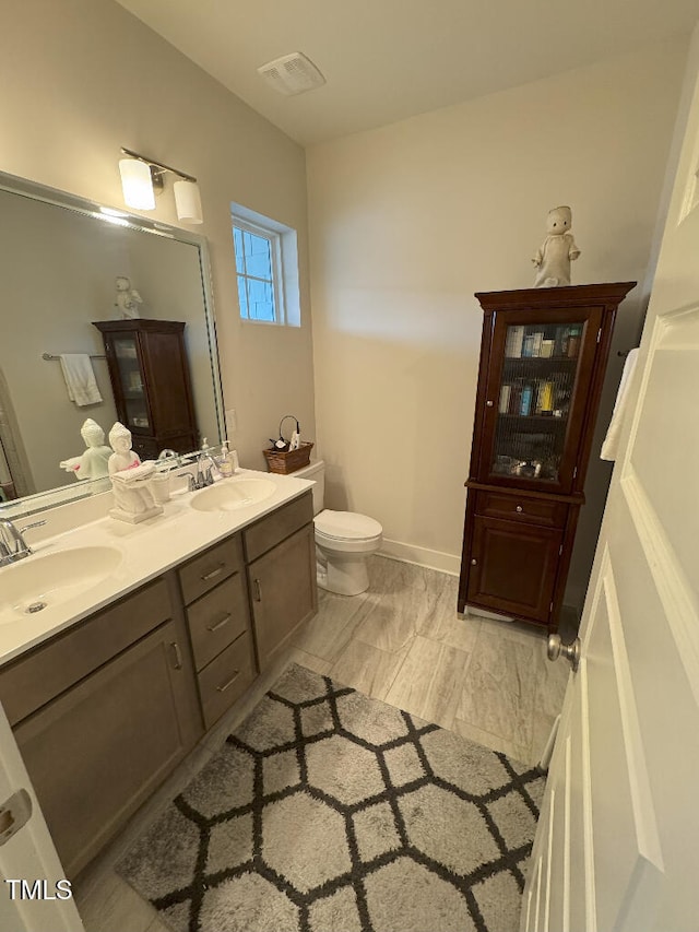 829 S Franklin St, Wake Forest, NC 27587 - full bathroom with double vanity, toilet, baseboards, and a sink