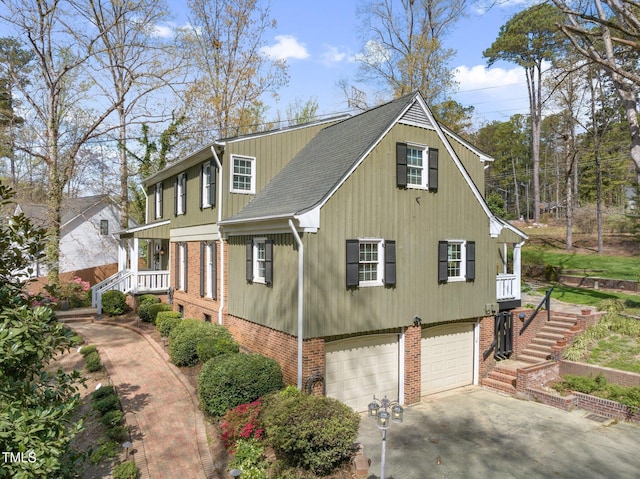 1302 Hermitage Rd, Sanford, NC 27330 - view of side of property with concrete driveway, an attached garage, brick siding, and stairway