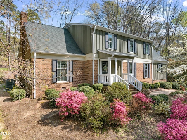 1302 Hermitage Rd, Sanford, NC 27330 - traditional-style house featuring brick siding, a shingled roof, board and batten siding, and a chimney