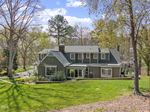 1302 Hermitage Rd, Sanford, NC 27330 - back of property featuring a yard, a chimney, and covered porch