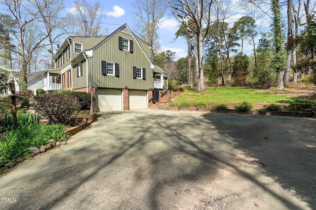 1302 Hermitage Rd, Sanford, NC 27330 - view of side of property featuring an attached garage, a yard, driveway, and brick siding
