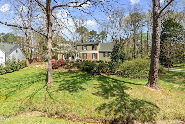 1302 Hermitage Rd, Sanford, NC 27330 - colonial inspired home with a front yard, fence, and brick siding
