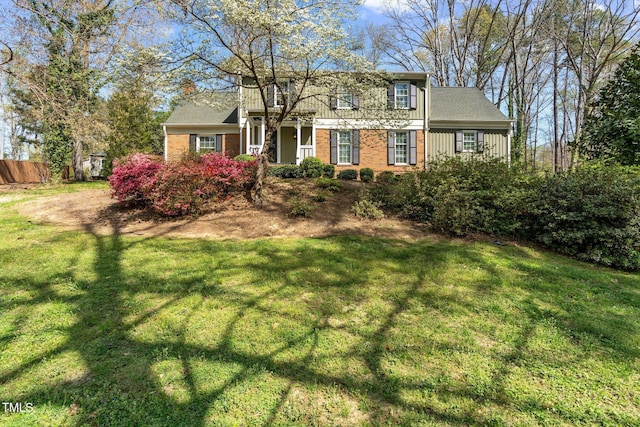 1302 Hermitage Rd, Sanford, NC 27330 - traditional-style house with a front yard and brick siding