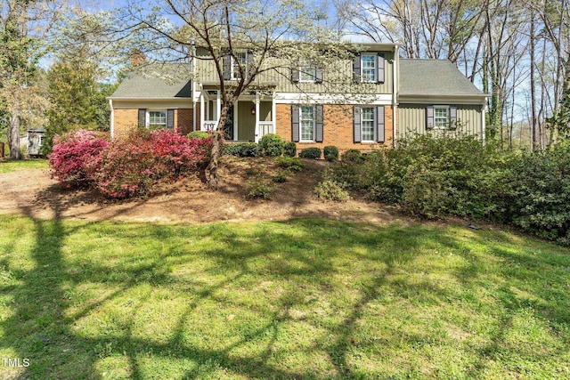 1302 Hermitage Rd, Sanford, NC 27330 - view of front of house featuring board and batten siding, a front lawn, and brick siding