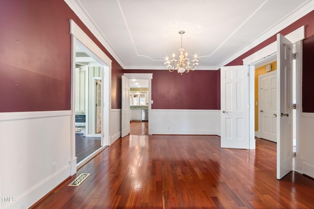 1302 Hermitage Rd, Sanford, NC 27330 - unfurnished dining area with an inviting chandelier, crown molding, wainscoting, visible vents, and wood finished floors
