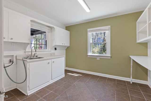 1302 Hermitage Rd, Sanford, NC 27330 - laundry area with crown molding, baseboards, cabinet space, and a sink
