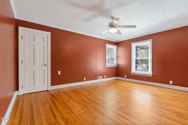 1302 Hermitage Rd, Sanford, NC 27330 - unfurnished room with visible vents, baseboards, light wood-style floors, ceiling fan, and crown molding