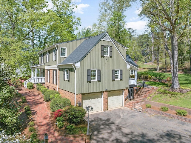 1302 Hermitage Rd, Sanford, NC 27330 - view of side of home featuring stairway, roof with shingles, an attached garage, driveway, and brick siding