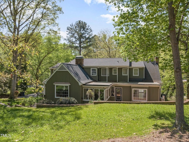 1302 Hermitage Rd, Sanford, NC 27330 - back of house featuring a chimney and a yard