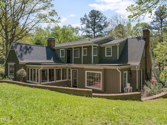 1302 Hermitage Rd, Sanford, NC 27330 - rear view of property with a chimney, a shingled roof, and a lawn