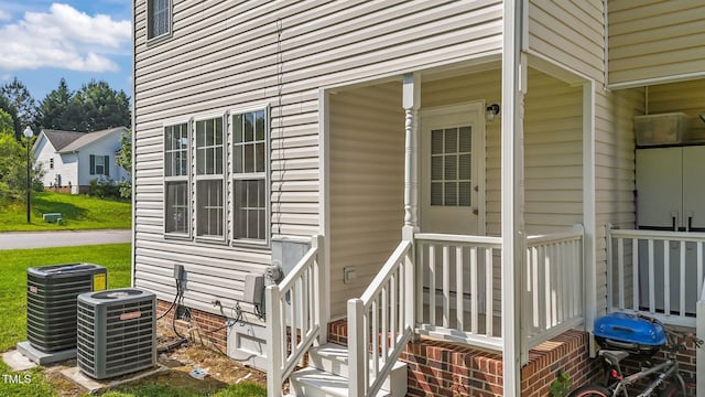 view of exterior entry with crawl space and cooling unit
