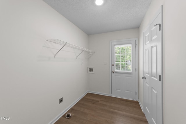 laundry room featuring laundry area, wood finished floors, baseboards, a textured ceiling, and washer hookup
