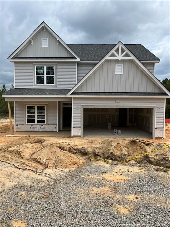200 Dove Rd, Cameron, NC 28326 - view of front of house featuring a shingled roof, a porch, a garage, board and batten siding, and driveway