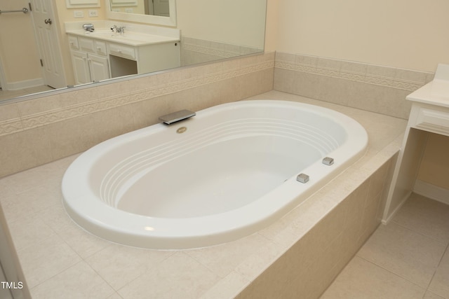 bathroom with tile patterned flooring, vanity, and a garden tub