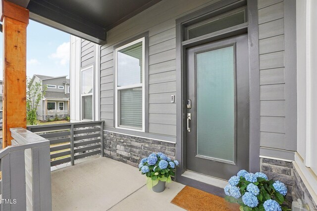5616 Horsewalk Cir, Raleigh, NC 27606 - view of exterior entry featuring stone siding