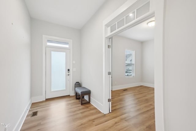 5616 Horsewalk Cir, Raleigh, NC 27606 - doorway to outside with visible vents, a wealth of natural light, and light wood-style floors
