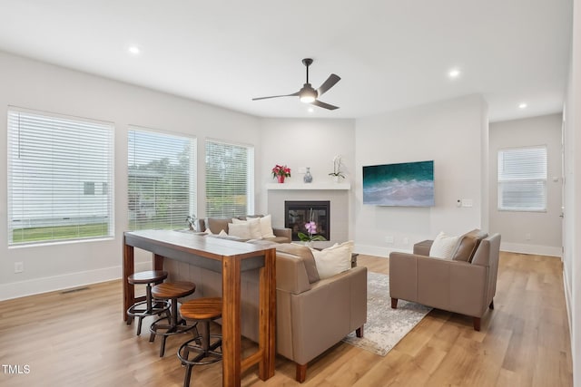 5616 Horsewalk Cir, Raleigh, NC 27606 - living area featuring visible vents, a ceiling fan, light wood-style floors, recessed lighting, and a glass covered fireplace