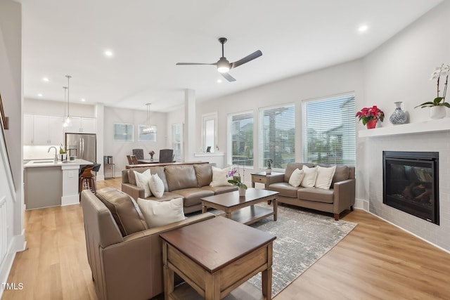 5616 Horsewalk Cir, Raleigh, NC 27606 - living area with ceiling fan, light wood finished floors, a glass covered fireplace, and recessed lighting