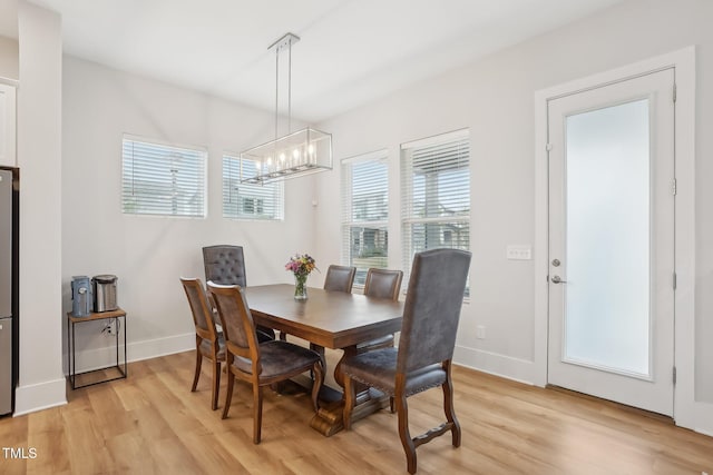 5616 Horsewalk Cir, Raleigh, NC 27606 - dining space featuring a chandelier, light wood finished floors, and baseboards