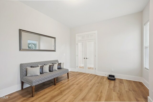 5616 Horsewalk Cir, Raleigh, NC 27606 - sitting room with plenty of natural light, french doors, baseboards, and wood finished floors