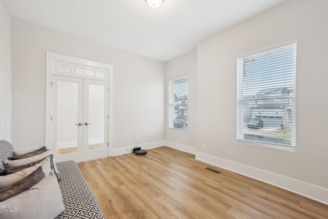 5616 Horsewalk Cir, Raleigh, NC 27606 - unfurnished bedroom with light wood-style floors, visible vents, baseboards, and french doors