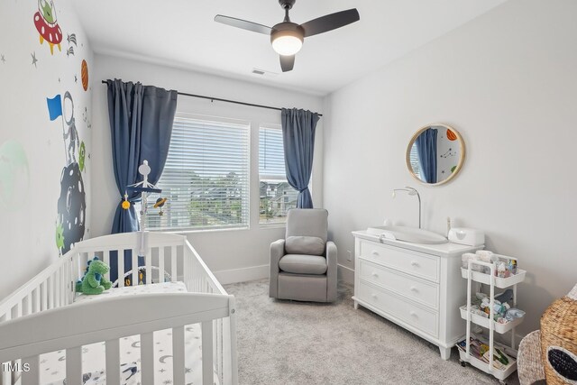 5616 Horsewalk Cir, Raleigh, NC 27606 - bedroom with baseboards, light carpet, visible vents, a nursery area, and ceiling fan