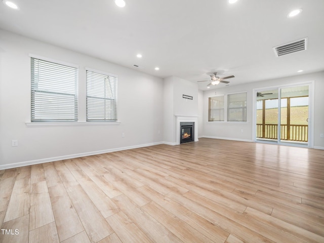 unfurnished living room with light wood finished floors, visible vents, a ceiling fan, and recessed lighting