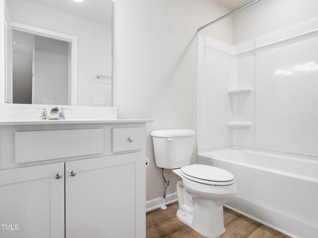 full bath featuring toilet, baseboards, vanity, and wood finished floors