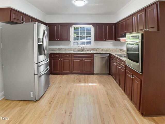 4601 Pemberton Dr, Raleigh, NC 27609 - kitchen featuring stainless steel appliances, light wood-style floors, and light stone countertops